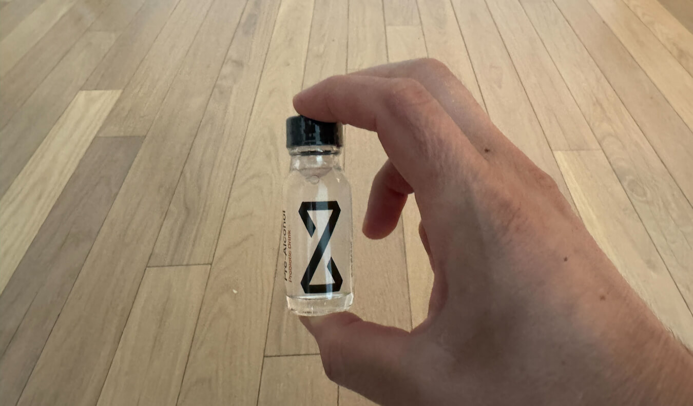 Nomadic Matt holding a small bottle of Zbiotics